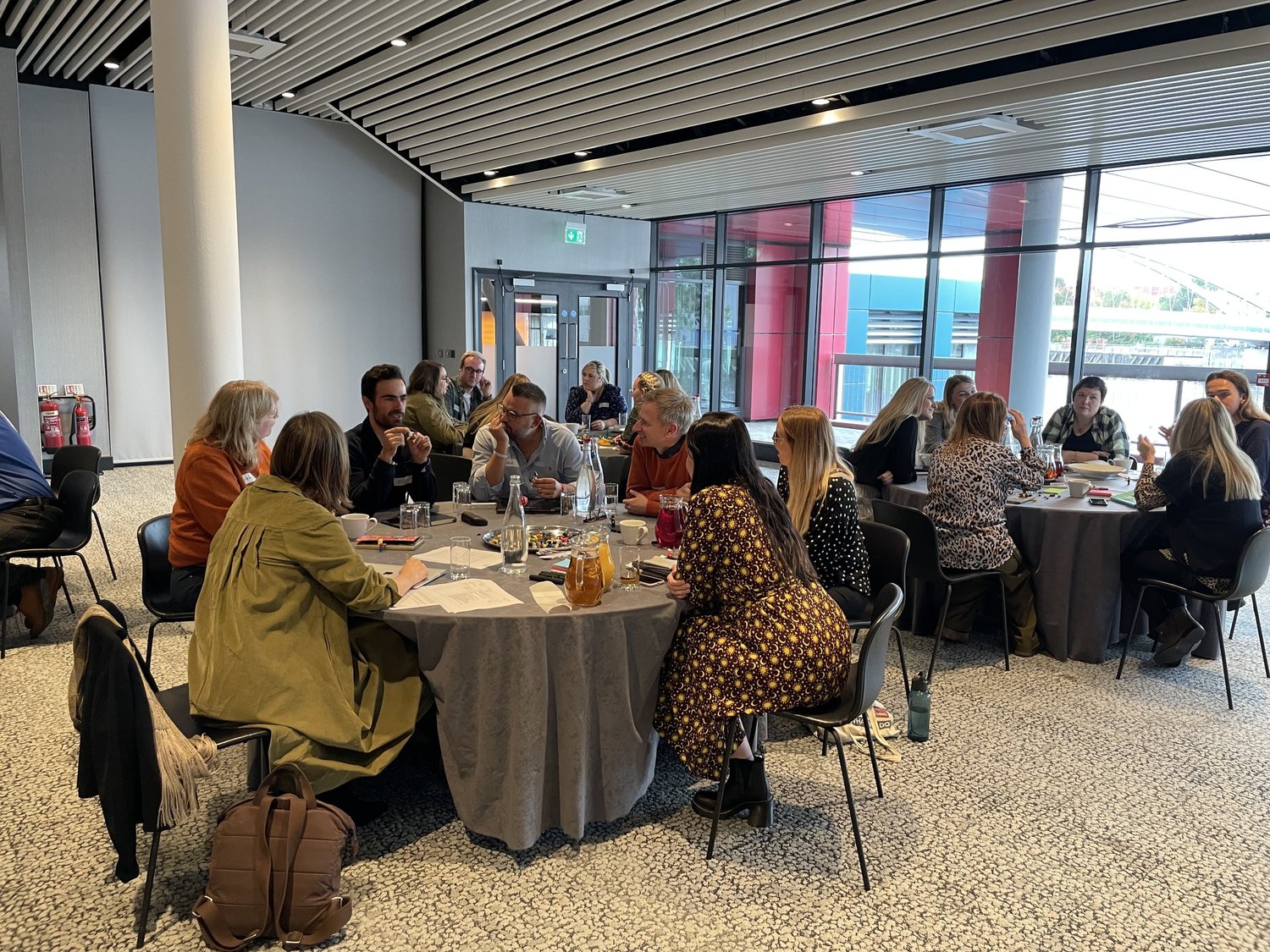 A facilitated group session around tables